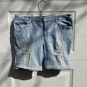Jean shorts size 10 petite rips on both legs in front. Hem folded. Light blue